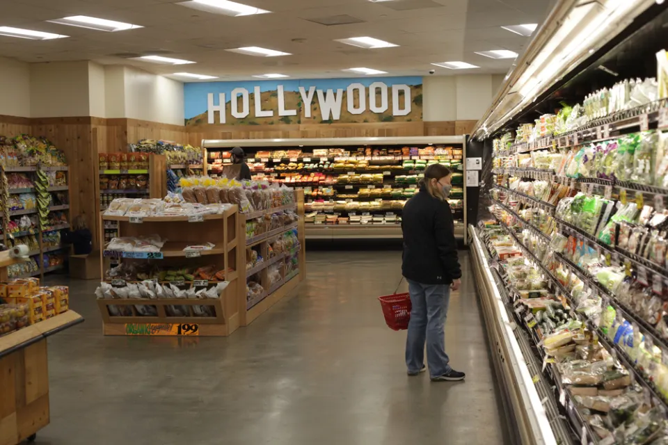 A woman in a mask shops at Trader Joe's.